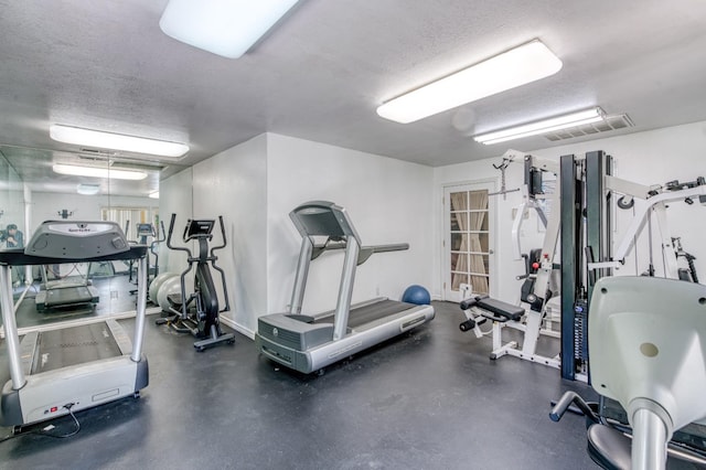 gym with a textured ceiling