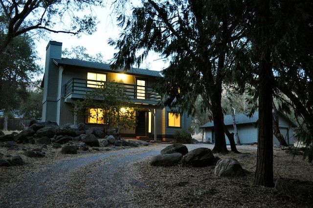43777 Kaweah River Dr, Three Rivers, CA 93271 - view of front facade with a chimney and a balcony