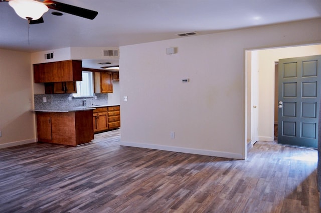 43777 Kaweah River Dr, Three Rivers, CA 93271 - kitchen with a ceiling fan, dark wood-type flooring, brown cabinets, tasteful backsplash, and baseboards