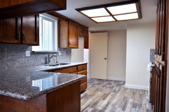 43777 Kaweah River Dr, Three Rivers, CA 93271 - kitchen featuring a sink, decorative backsplash, baseboards, light wood-type flooring, and light stone counters