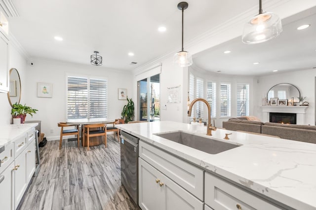 261 N Terry Ave, Clovis, CA 93612 - kitchen with a sink, crown molding, stainless steel dishwasher, a lit fireplace, and recessed lighting