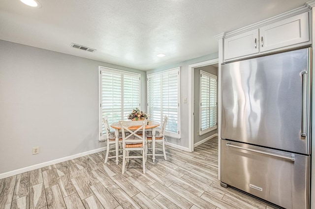 6619 N Valentine Ave, Fresno, CA 93711 - dining space featuring light wood finished floors, a textured ceiling, and recessed lighting