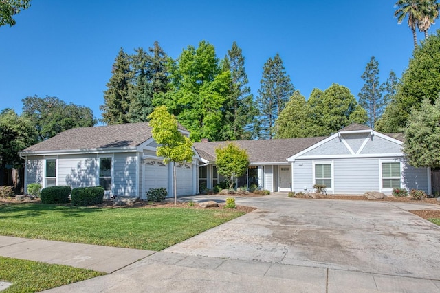 6619 N Valentine Ave, Fresno, CA 93711 - ranch-style home featuring concrete driveway, a front yard, an attached garage, and a chimney