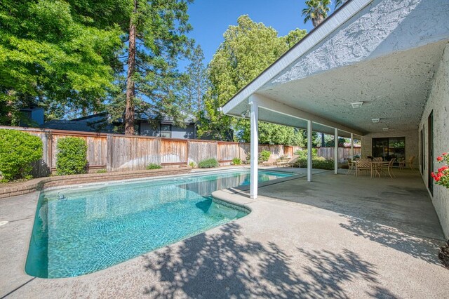 6619 N Valentine Ave, Fresno, CA 93711 - view of pool featuring a fenced backyard, a patio area, and outdoor dining area