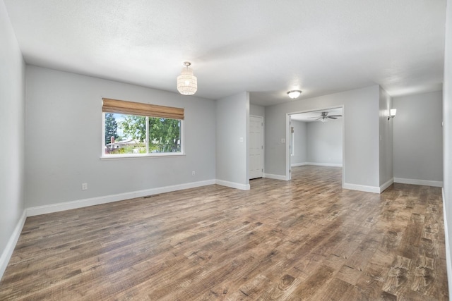 spare room with wood finished floors and baseboards
