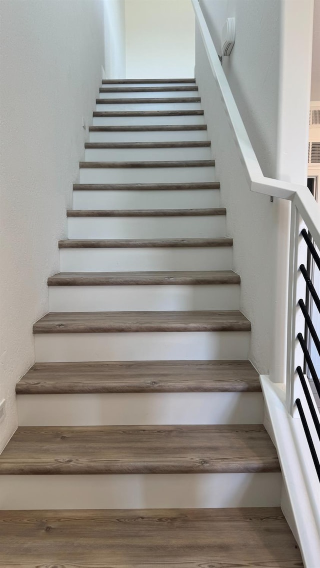 stairs featuring wood finished floors
