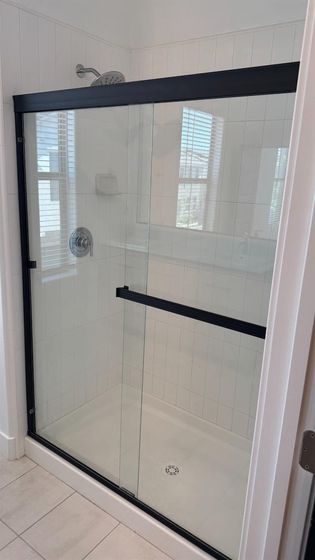 full bathroom with tile patterned flooring and a stall shower