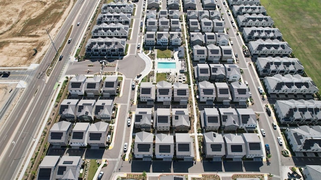 view of property location with nearby suburban area and a pool