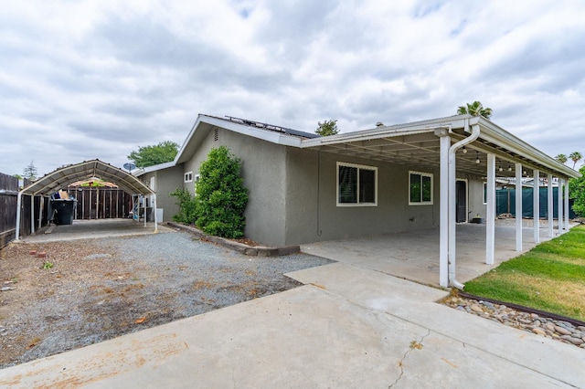424 W Menlo Ave, Clovis, CA 93612 - view of home's exterior with stucco siding, fence, concrete driveway, and an attached carport