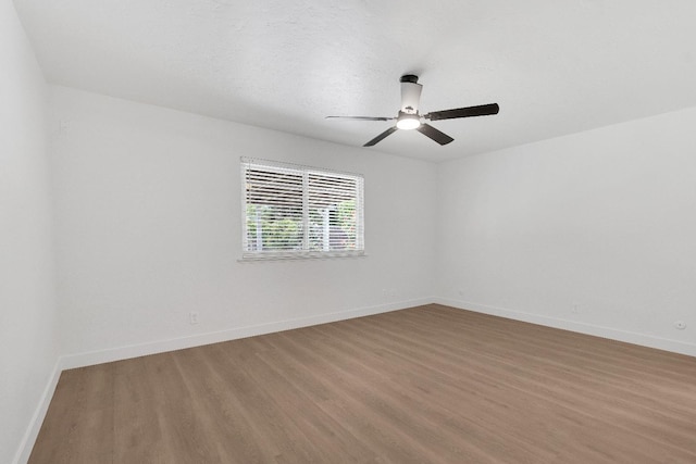 424 W Menlo Ave, Clovis, CA 93612 - empty room with wood finished floors, ceiling fan, and baseboards