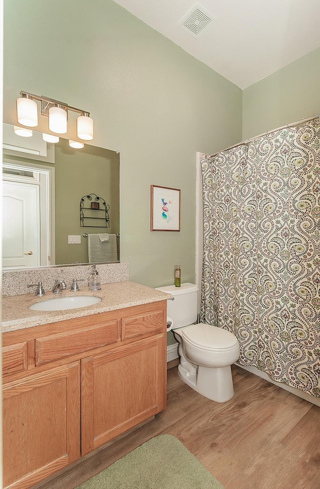 287 W Trenton Ave, Clovis, CA 93619 - full bath with wood finished floors, toilet, vanity, and a shower with curtain