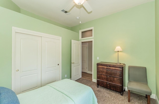 carpeted bedroom with a closet, baseboards, and ceiling fan