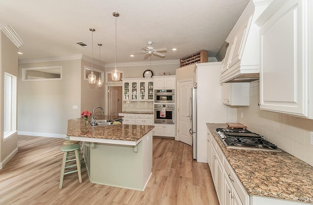 287 W Trenton Ave, Clovis, CA 93619 - kitchen with a sink, appliances with stainless steel finishes, ceiling fan, premium range hood, and decorative backsplash
