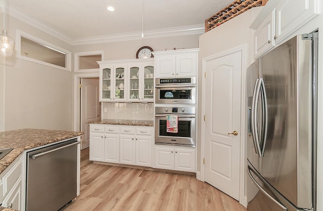 287 W Trenton Ave, Clovis, CA 93619 - kitchen with appliances with stainless steel finishes, white cabinetry, ornamental molding, and dark stone counters
