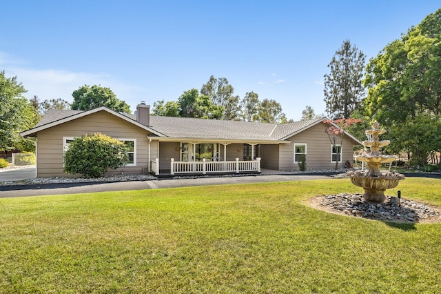 13801 E Rialto Ave, Sanger, CA 93657 - ranch-style home featuring a chimney, a front yard, a porch, and roof with shingles