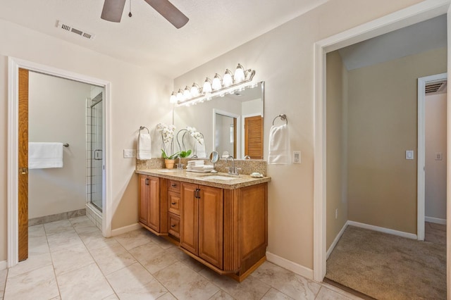 13801 E Rialto Ave, Sanger, CA 93657 - full bath with a ceiling fan, double vanity, a stall shower, and baseboards