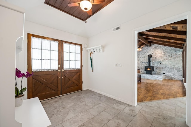 13801 E Rialto Ave, Sanger, CA 93657 - foyer with brick wall, wood ceiling, ceiling fan, a wood stove, and baseboards