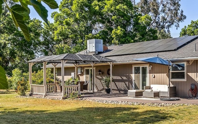 13801 E Rialto Ave, Sanger, CA 93657 - rear view of property featuring solar panels, a patio, a lawn, roof with shingles, and a chimney
