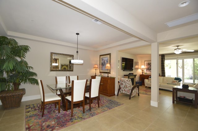 dining room with light tile patterned flooring, baseboards, and ceiling fan