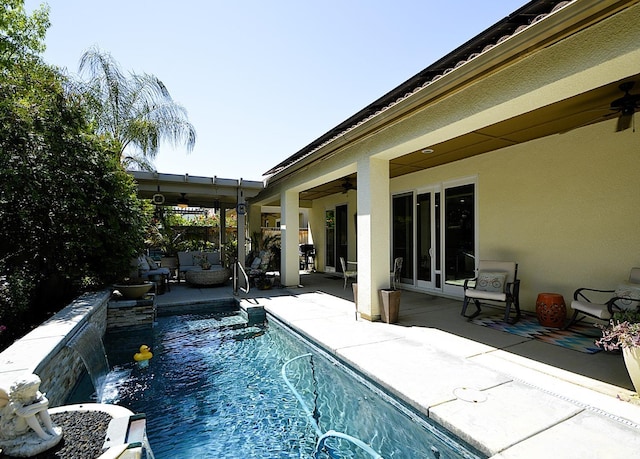 outdoor pool with a ceiling fan and a patio