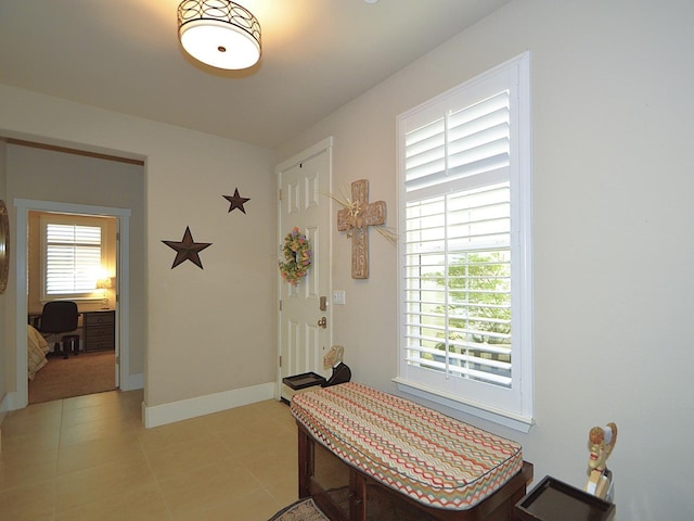 dining area with light tile patterned floors, baseboards, and an office area