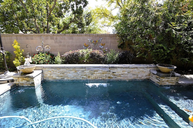 view of swimming pool with fence