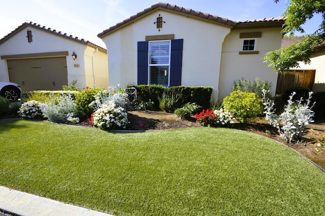 3476 Trenton Ln, Clovis, CA 93619 - view of front of property featuring a tiled roof, a front yard, stucco siding, and a garage