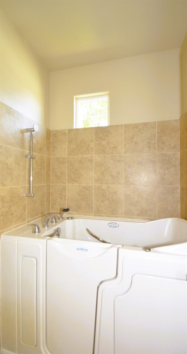 bathroom with a garden tub