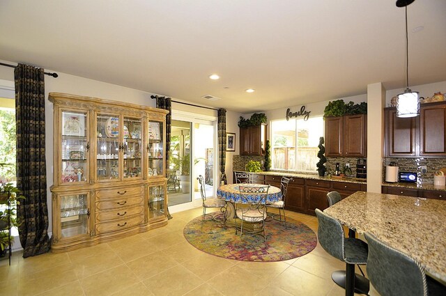 3476 Trenton Ln, Clovis, CA 93619 - kitchen featuring healthy amount of natural light, decorative backsplash, light stone counters, and recessed lighting