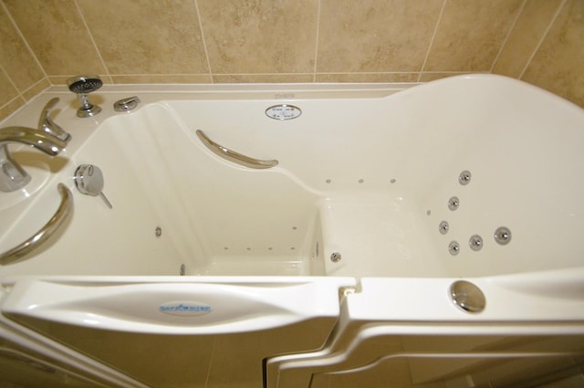 bathroom view of a tub with jets