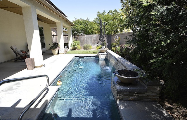 view of pool with a fenced backyard and a patio