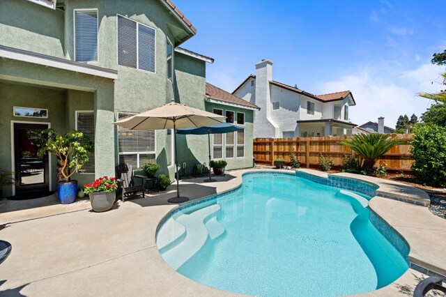view of pool featuring a fenced backyard and a patio area