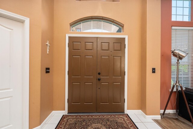 entrance foyer featuring tile patterned floors and baseboards