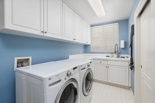 clothes washing area with cabinet space, independent washer and dryer, and light tile patterned floors
