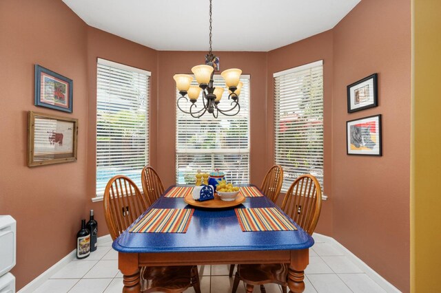 dining space featuring a chandelier, light tile patterned floors, and healthy amount of natural light