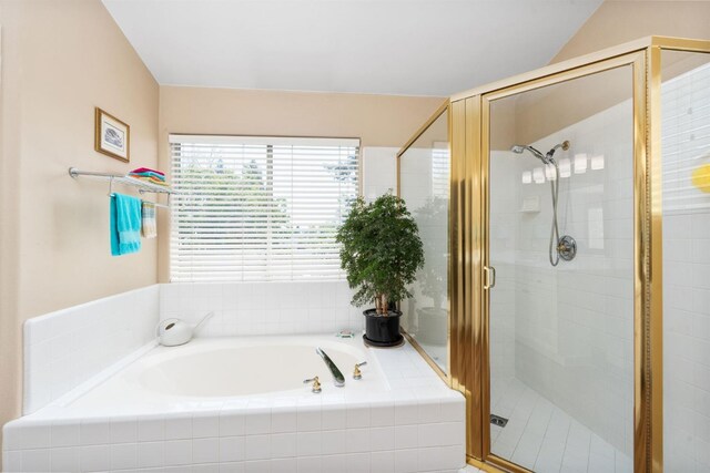 bathroom with a bath and a stall shower