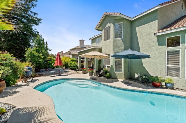 outdoor pool with a patio area