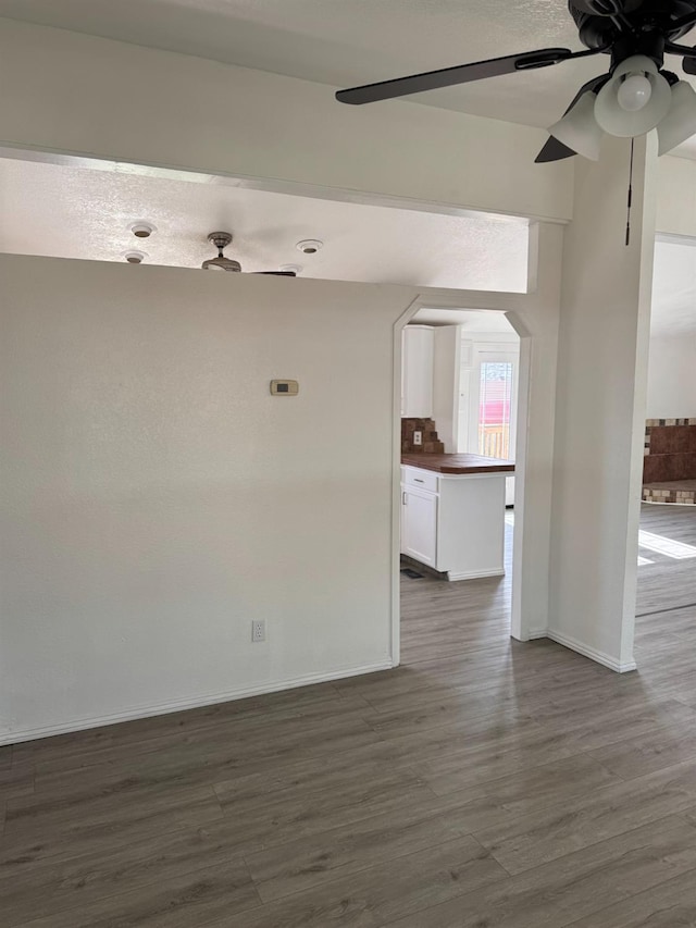 28640 Ward St, Madera, CA 93638 - unfurnished room with dark wood-style flooring, ceiling fan, and baseboards