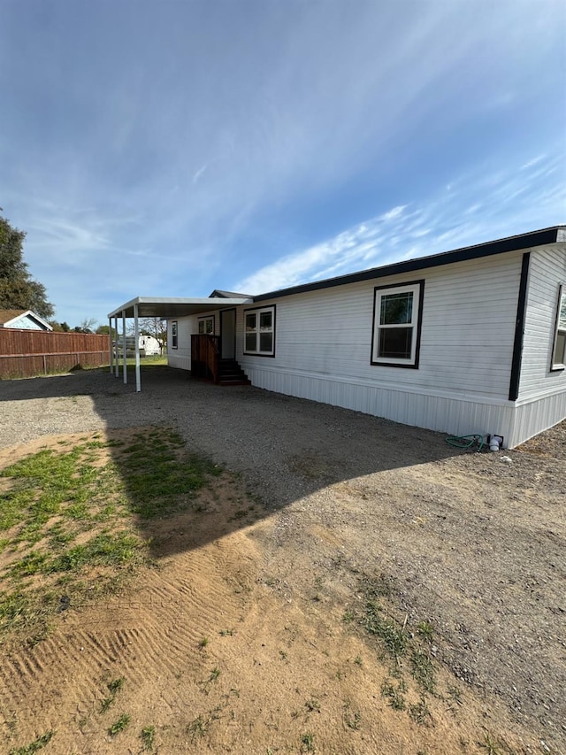 28640 Ward St, Madera, CA 93638 - rear view of house with fence and dirt driveway