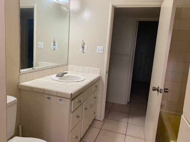 full bath featuring tile patterned flooring, vanity, and toilet