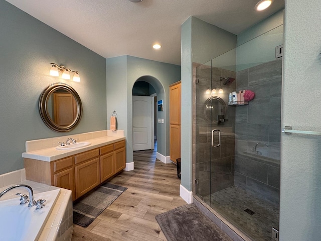 1822 N Magnolia, Clovis, CA 93619 - full bathroom featuring wood finished floors, a stall shower, a bath, recessed lighting, and vanity