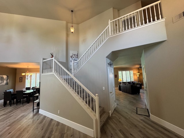 1822 N Magnolia, Clovis, CA 93619 - stairway featuring wood finished floors, healthy amount of natural light, a chandelier, baseboards, and a towering ceiling
