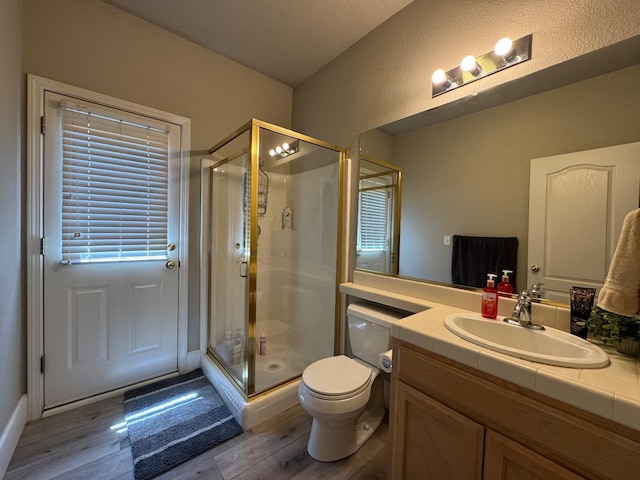 1822 N Magnolia, Clovis, CA 93619 - bathroom with wood finished floors, a stall shower, vanity, and toilet