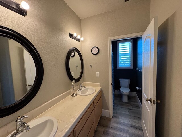 1822 N Magnolia, Clovis, CA 93619 - bathroom with toilet, wood finished floors, baseboards, and double vanity