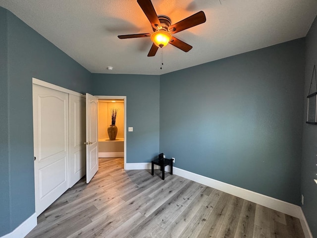 1822 N Magnolia, Clovis, CA 93619 - unfurnished bedroom featuring light wood-style floors, baseboards, a closet, and ceiling fan
