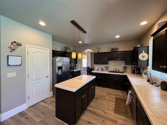 1822 N Magnolia, Clovis, CA 93619 - kitchen featuring tile counters, a kitchen island, a sink, light wood-type flooring, and recessed lighting
