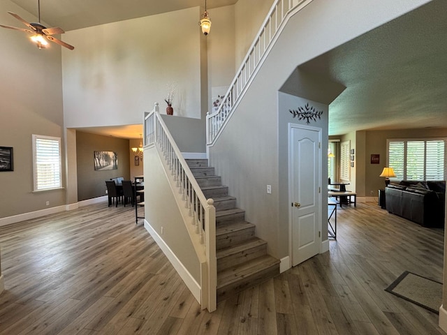 1822 N Magnolia, Clovis, CA 93619 - staircase with a high ceiling, wood finished floors, ceiling fan, and baseboards