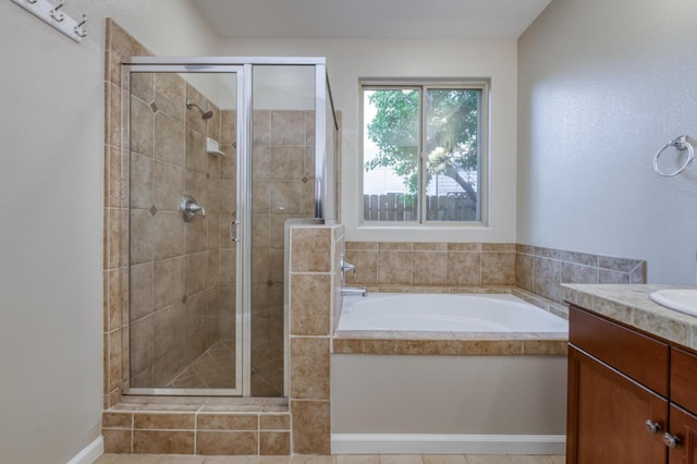 full bathroom featuring a shower stall, a garden tub, and vanity