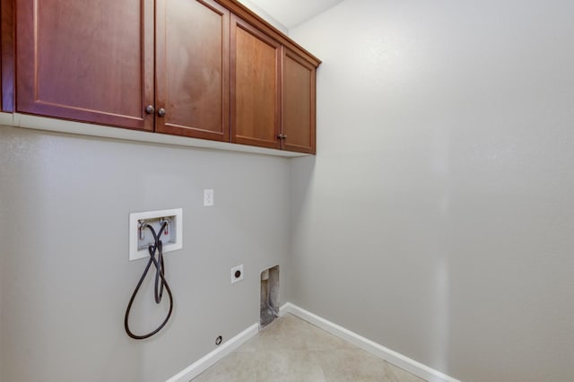 washroom featuring cabinet space, electric dryer hookup, hookup for a washing machine, hookup for a gas dryer, and baseboards