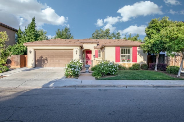 view of front of property with an attached garage, concrete driveway, stucco siding, and a tiled roof